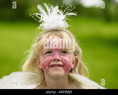 Girl with a butterfly painted on his face Stock Photo