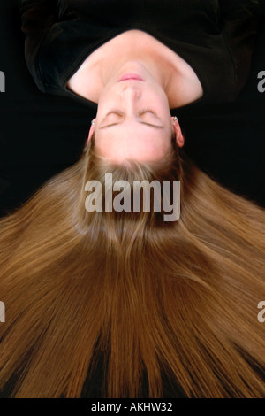 Looking down on a pretty young woman with hair radiating around her head Stock Photo