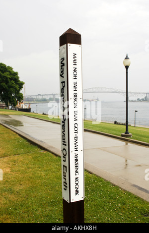 May Peace prevail on Earth multiple language signpost Stock Photo