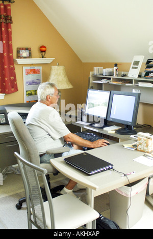 A man sitting at his desk in  home office environment in America USA Stock Photo