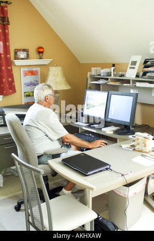 A man sitting at his desk in  home office environment in America USA Stock Photo