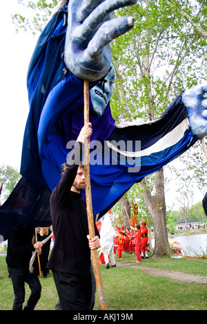 Puppeteers carrying puppets in Tree of Life Ceremony. MayDay Parade and Festival Powderhorn Park. Minneapolis Minnesota USA Stock Photo