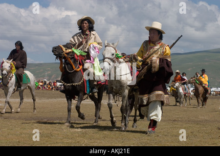 Khampas the warrior horseman of old Tibet compete at the Litang Horse Festival Kham Sichuan Province China Tibet  Stock Photo