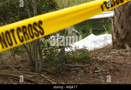 Foot of Caucasian Female Dead Body Protruding from Under White Sheet in South Carolina Swamp USA, Crime Scene Stock Photo