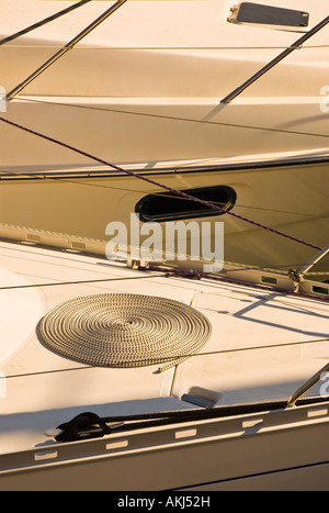 Neatly coiled mooring rope on the bow of a yacht. Stock Photo