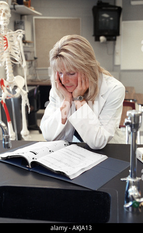 Female biologist chemist does research studies in a laboratory Stock Photo