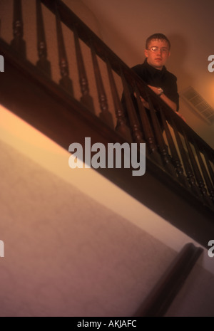 Man in Black on Stairs Looking Down Stock Photo