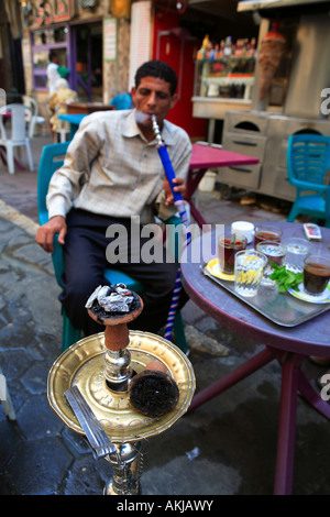 Man smoking water pipe downtown Cairo Egypt Stock Photo - Alamy