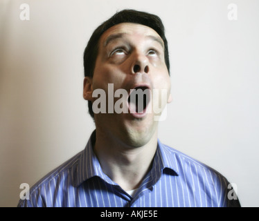 Man looks upwards to the sky in amazement Stock Photo