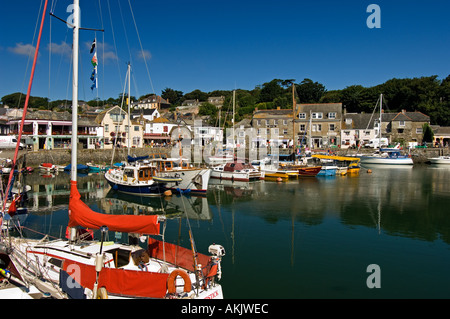 The beautiful scenic harbour of Padstow Cornwall England where fishing boats rub gunnels with luxury cabin cruisers Stock Photo