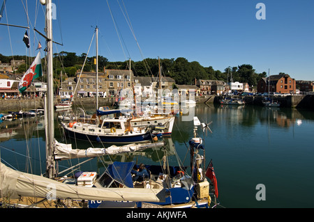 The beautiful scenic harbour of Padstow Cornwall England where fishing boats rub gunnels with luxury cabin cruisers Stock Photo