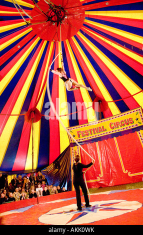 Festival Circus girl swinging on a rope high up in the air under a big top circus tent Wickerman Music Festival Scotland UK Stock Photo