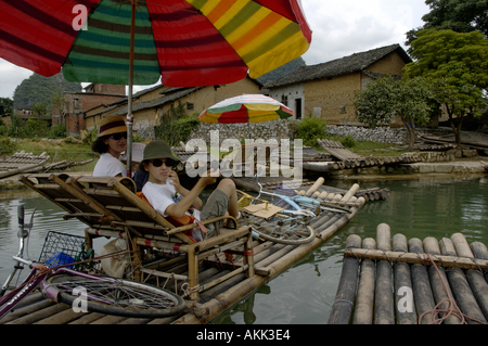 China Guangxi Yangshuo A European Family On A Bamboo Raft About To Navigate On The Yulong River Stock Photo