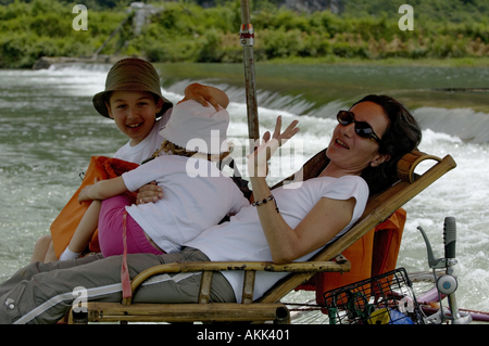 Family on a bamboo raft travelling down the Yulong River,  Yangshuo, Guangxi, China. Stock Photo