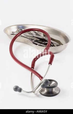 Stethoscope and medical instruments lying on a white desk Stock Photo