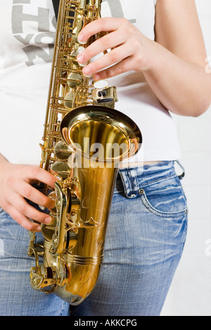 Young saxophone player with white t shirt and jeans Stock Photo