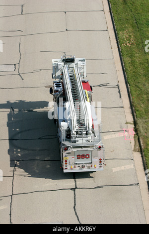 A ladder fire truck leaving an emergency scene Stock Photo