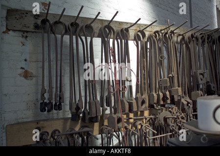 Blacksmiths tools hanging in the forge blacksmiths workshop at National Waterways Museum Cheshire UK Stock Photo