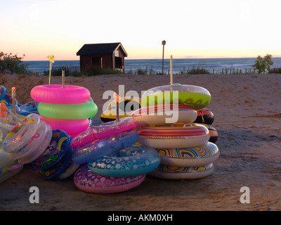 Canada Ontario Sauble Beach beach floatation devices at a beach stand illuminated at dusk with beach in background Stock Photo