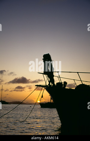 BVI Cooper Island romantic couple on bow of boat at sunset Stock Photo