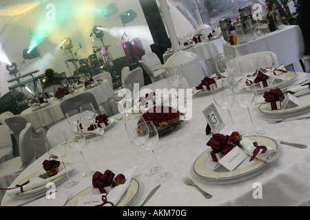 A general view of some laid tables at a wedding reception party. You can see all of the cutlery on the decorated tables. Stock Photo