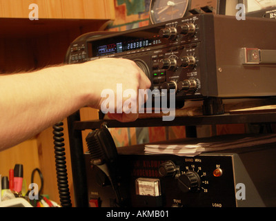 Operating Ham Radio Equipment.An amateur setup in a bedroom. Stock Photo