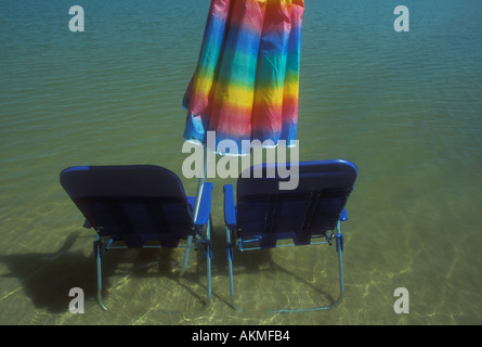 Umbrella and Chairs in Water Stock Photo