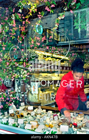 Paris France, French Cheese Store 'Alleosse' Fromages Window Display Fresh Food, woman in french window, fromagerie Paris Stock Photo