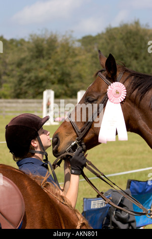 Equestrian competitor showing affection for her award winning horse Stock Photo