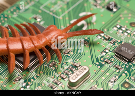 Digital close up photograph of a computer circuit board with a bug crawling over it Stock Photo
