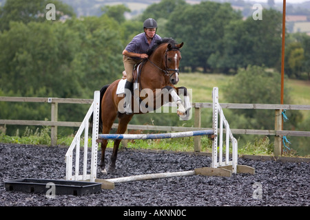 Young man schools a Dutch Warmblood horse Oxfordshire England Stock Photo