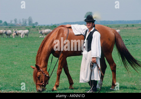 Traditional Csikos Cowboy with his horse on the Great Hungarian Plains in Bugac Hungary Stock Photo