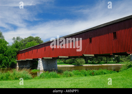 The red West Montrose Covered Bridge in Ontario called Kissing bridge over Grand river in Mennonite country Elora Stock Photo