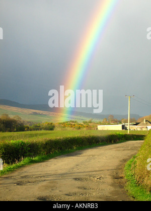 Rainbow in the sky against dark dramatic clouds Stock Photo - Alamy