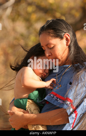 A Native American Indian mother holding her baby boy who was upset Stock Photo