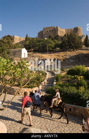 Tourists riding on donkeys to Acropolis Lindos Rhodes Greece Stock Photo