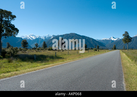 Open Road with a view towards Mount Cook and Mount Tasman near Lake Matheson, Fox Glacier, South Island, New Zealand Stock Photo