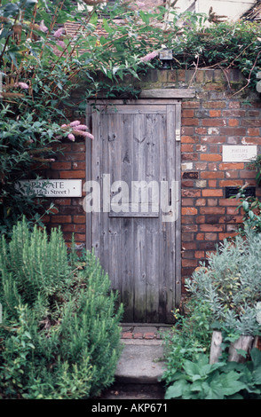 Wooden garden door concealed in a brick wall Rochester Kent, England UK Stock Photo