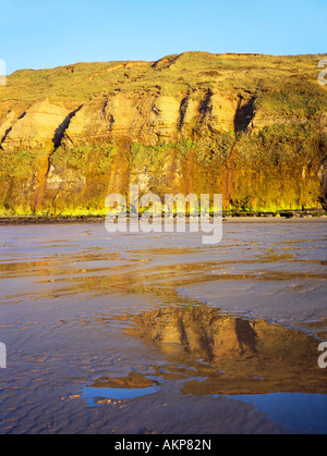 Huntcliff reflected in the beach at Saltburn-by-the-sea, on the North Yorkshire coast. Stock Photo