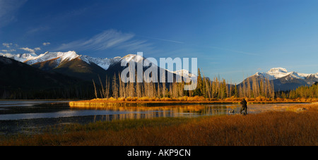 Panorama of photographer on First Vermilion Lake at sunrise in the Fall Canadian Rocky Mountains Banff National Park Alberta Canada Stock Photo