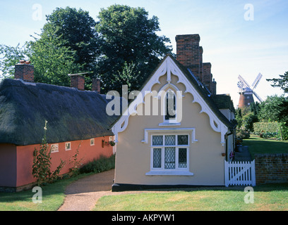 Three historical buildings Thaxted Essex village thatched cottage (left) almshouse building in churchyard with John Webb's Windmill beyond England UK Stock Photo