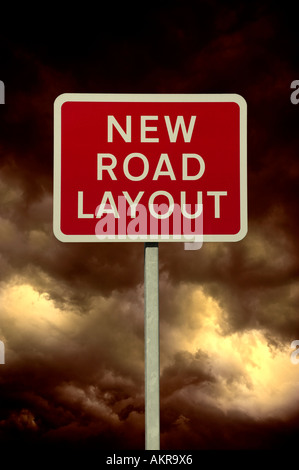 RED NEW ROAD LAYOUT WARNING SIGN WITH STORMY SKY AND CLOUDS IN BACKGROUND Stock Photo