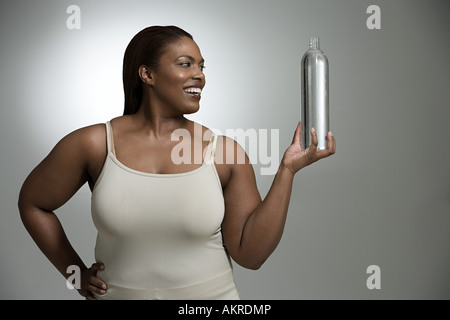 Woman holding bottle of water Stock Photo