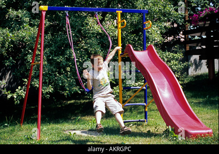 Boy jumping from a swing seesaw, danger Stock Photo