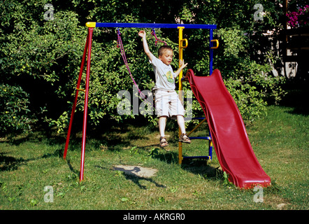 Boy jumping from a swing seesaw, danger Stock Photo