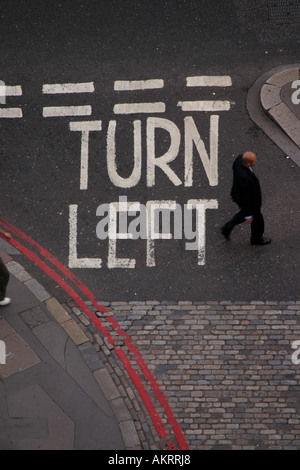 Looking down on a turn left sign at Monument Street in the City of London United Kingdom Stock Photo