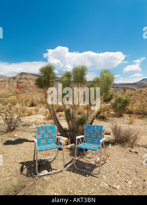 Empty plaid lawn chairs in desert landscape Stock Photo