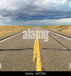 Empty two lane highway leading to desert horizon