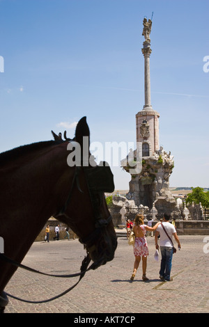 Cordoba Cordoba Province Spain Tourists and silhouetted horse in front of monument Triunfo de San Rafael Stock Photo