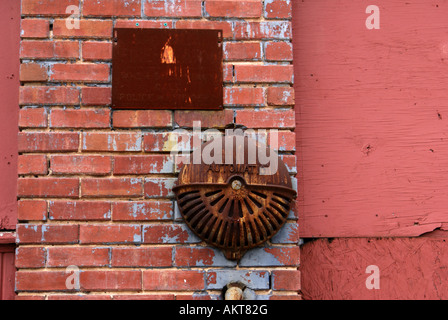 old fire alarm on red brick wall Stock Photo